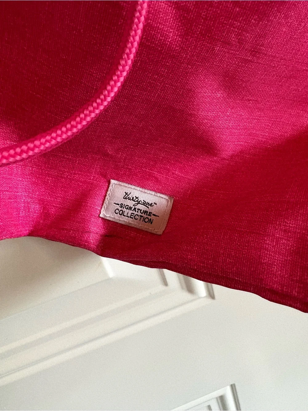 Cute personalized drawstring backpack in a vibrant pink fabric, letter L